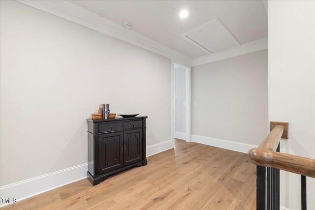 interior space with ornamental molding and light hardwood / wood-style flooring