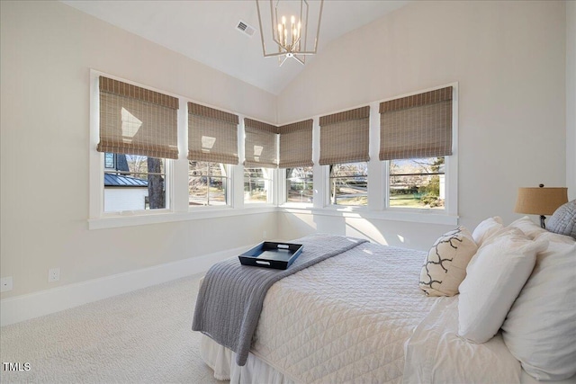 bedroom featuring lofted ceiling, a notable chandelier, and carpet floors