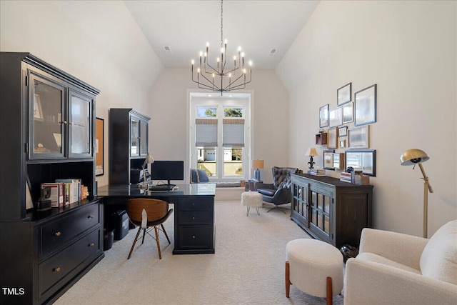 carpeted home office featuring an inviting chandelier and high vaulted ceiling