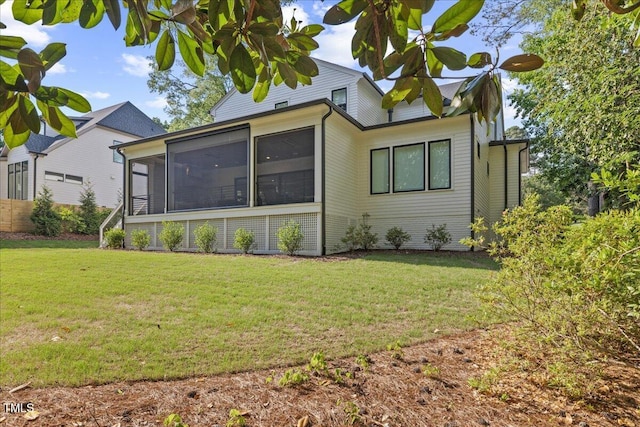 1304 Ivy Ln, Raleigh, NC 27609 - back of house featuring a lawn and a sunroom
