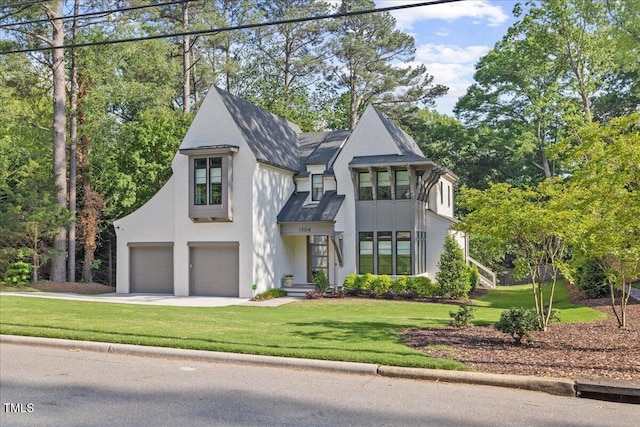 1304 Ivy Ln, Raleigh, NC 27609 - view of front of home with driveway, a front lawn, and a garage