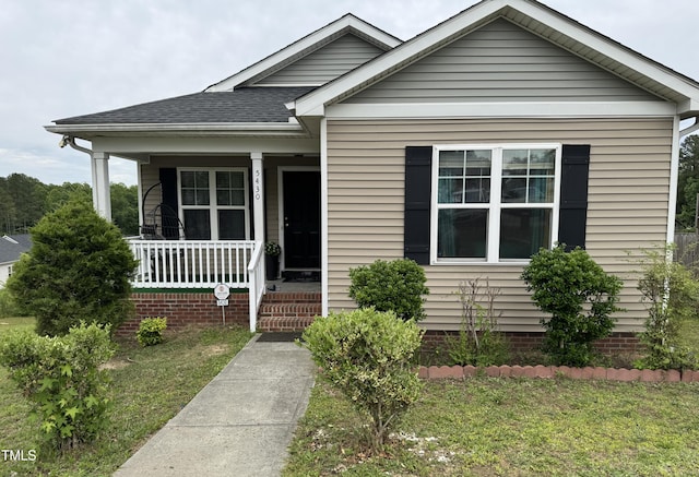 5430 Neuse Ridge Rd, Raleigh, NC 27610 - bungalow with a porch, a shingled roof, and a front lawn