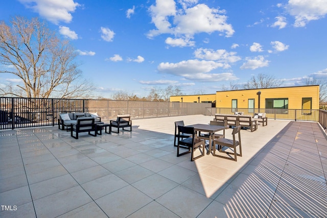 view of patio with outdoor dining area, outdoor lounge area, and fence