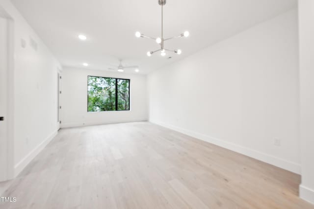 empty room featuring baseboards and light wood-style floors