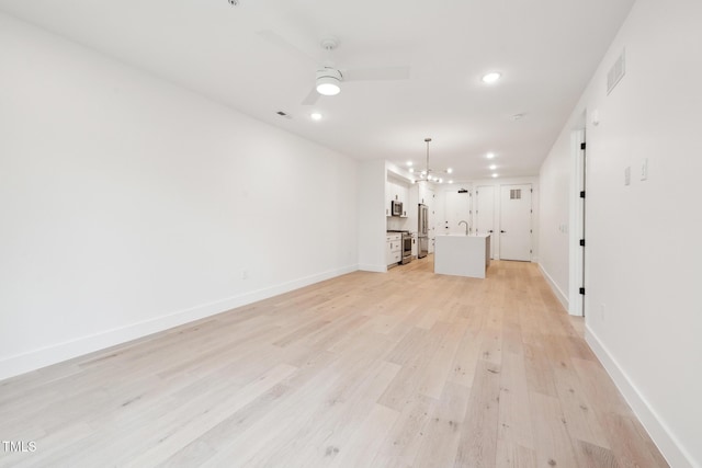 unfurnished living room with light wood-type flooring, visible vents, a ceiling fan, recessed lighting, and baseboards