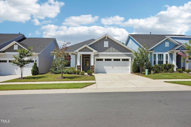 craftsman house featuring board and batten siding, concrete driveway, an attached garage, and a front lawn