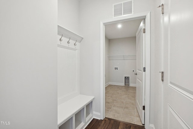 mudroom featuring dark wood-style floors, baseboards, and visible vents