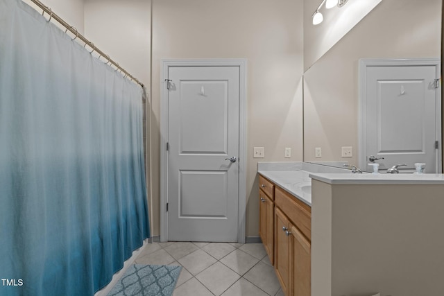 bathroom with tile patterned floors and vanity