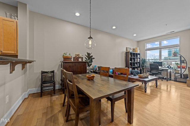 dining space featuring light wood-type flooring