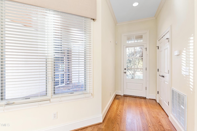 doorway to outside featuring crown molding and light hardwood / wood-style flooring