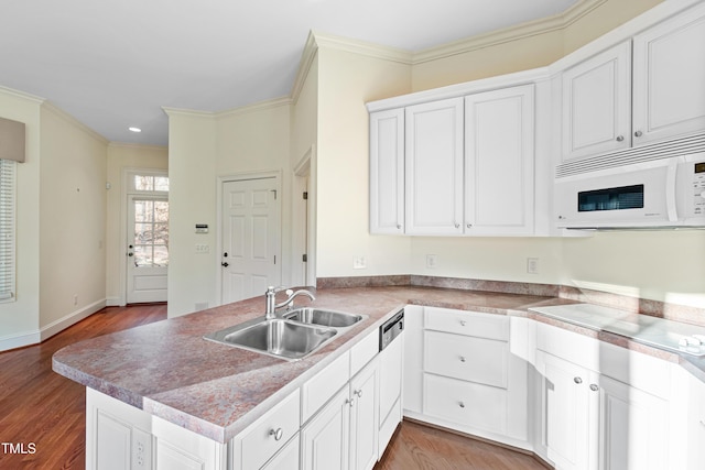 kitchen featuring white cabinetry, crown molding, kitchen peninsula, and sink