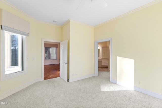 unfurnished bedroom featuring crown molding and light carpet