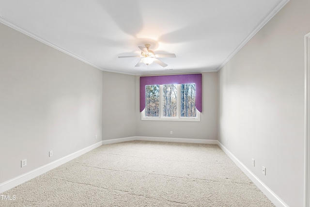 empty room featuring crown molding, carpet flooring, and ceiling fan