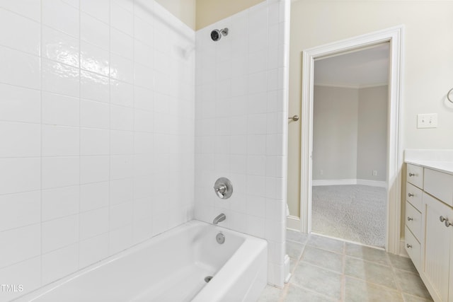 bathroom with crown molding, vanity, and tiled shower / bath combo