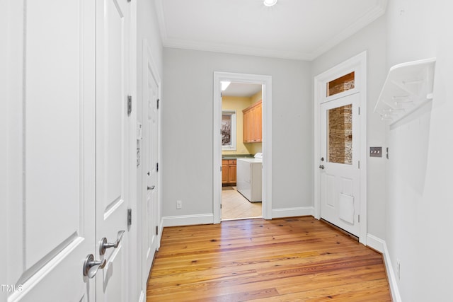 foyer with crown molding, washer / dryer, and light wood-type flooring