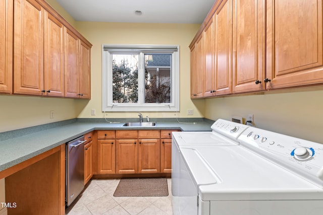 washroom with light tile patterned flooring, cabinets, separate washer and dryer, and sink