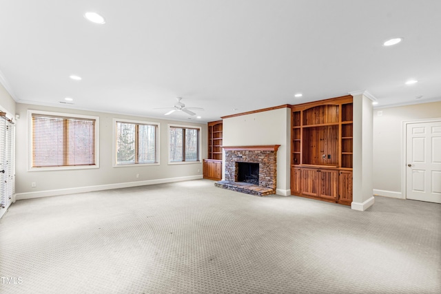 unfurnished living room featuring ornamental molding, light carpet, and ceiling fan