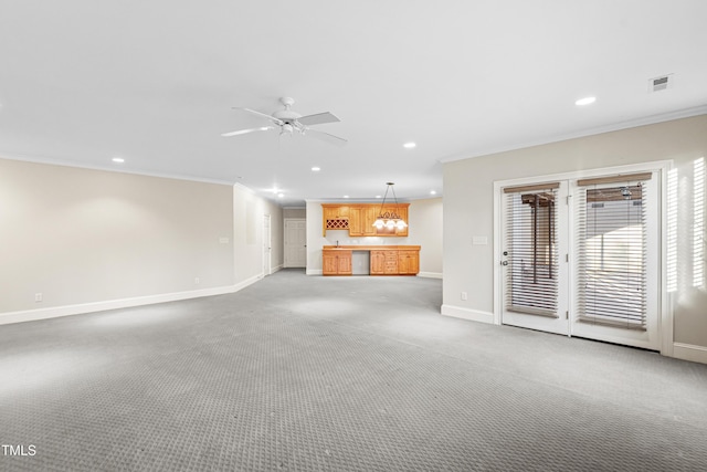 unfurnished living room with ornamental molding, ceiling fan, and carpet