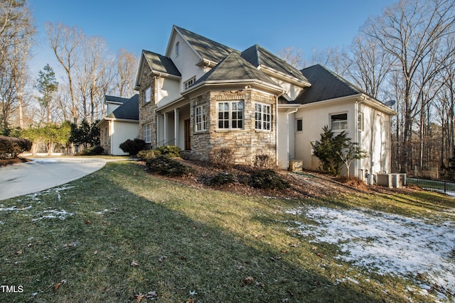 view of side of property with a yard