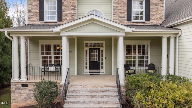 property entrance with crawl space, a porch, and roof with shingles