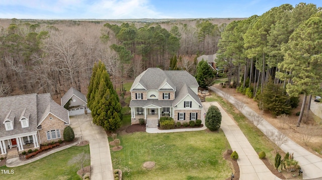 birds eye view of property with a view of trees