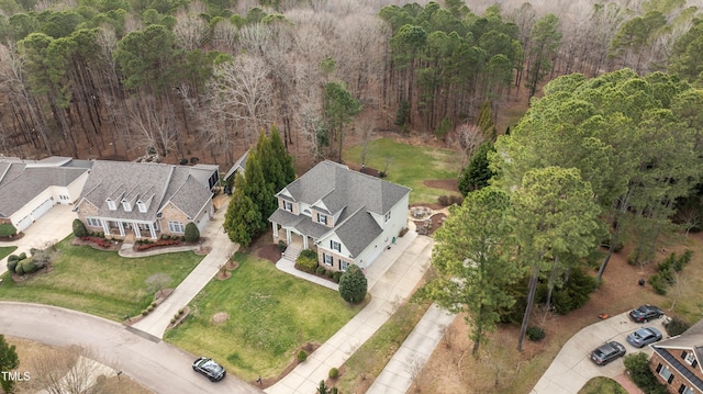 drone / aerial view featuring a wooded view