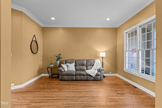 living room with light wood-style floors, baseboards, and crown molding