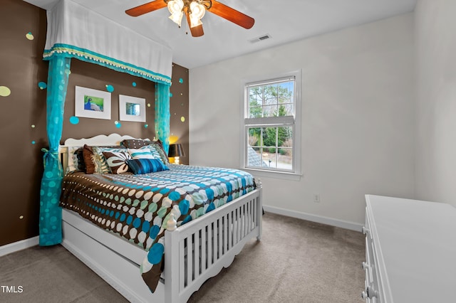 carpeted bedroom with baseboards, visible vents, and ceiling fan