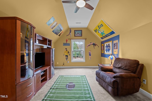 living area with light colored carpet, visible vents, vaulted ceiling, ceiling fan, and baseboards