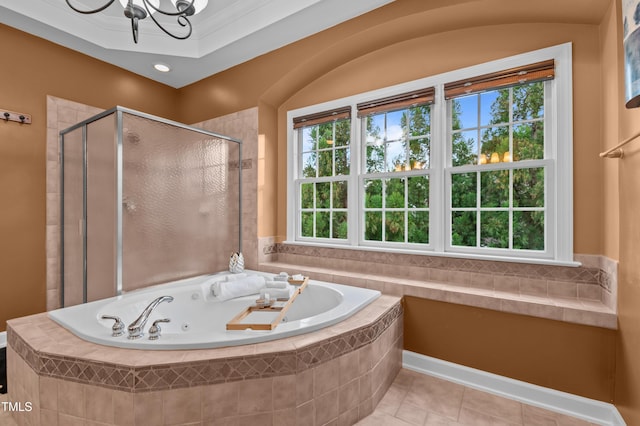 full bathroom featuring a whirlpool tub, a shower stall, a notable chandelier, and tile patterned floors