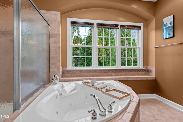 bathroom featuring tile patterned flooring, baseboards, and a whirlpool tub