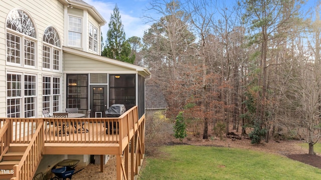 view of yard featuring a sunroom and a wooden deck