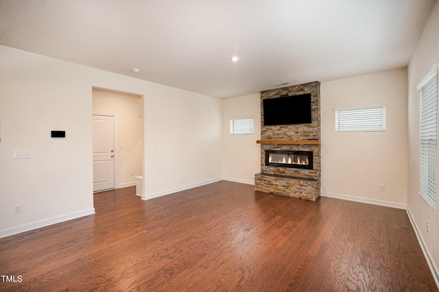 unfurnished living room with a fireplace and dark hardwood / wood-style flooring