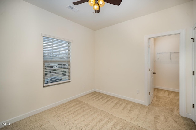 unfurnished room featuring ceiling fan and light carpet