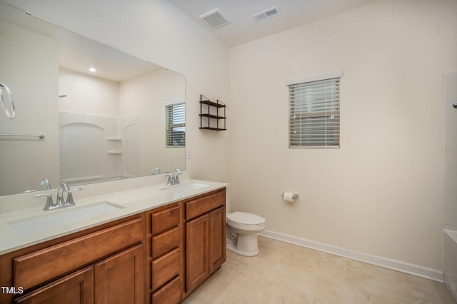 bathroom featuring vanity, toilet, and tile patterned flooring