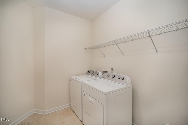 washroom featuring separate washer and dryer and light tile patterned floors