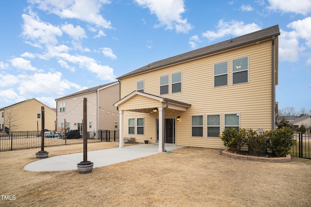 rear view of house featuring a yard and a patio