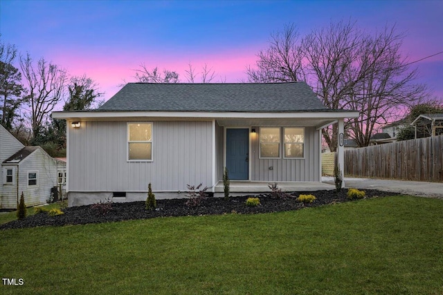 view of front of home with a porch and a lawn