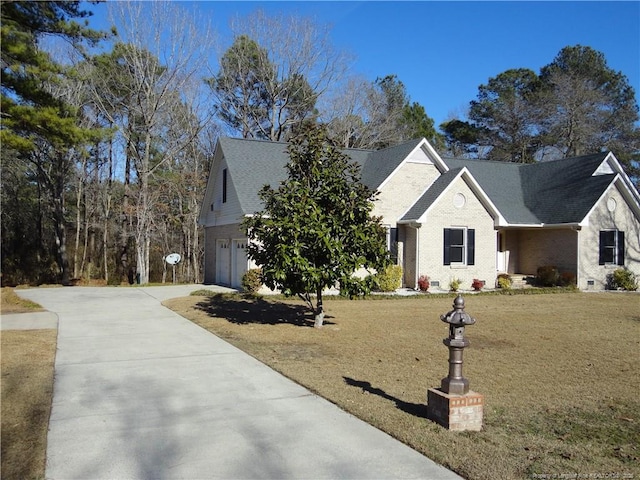 view of front of house with a garage and a front lawn