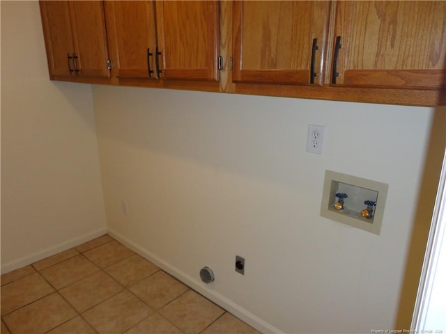 laundry room featuring light tile patterned flooring, cabinets, hookup for a washing machine, and electric dryer hookup