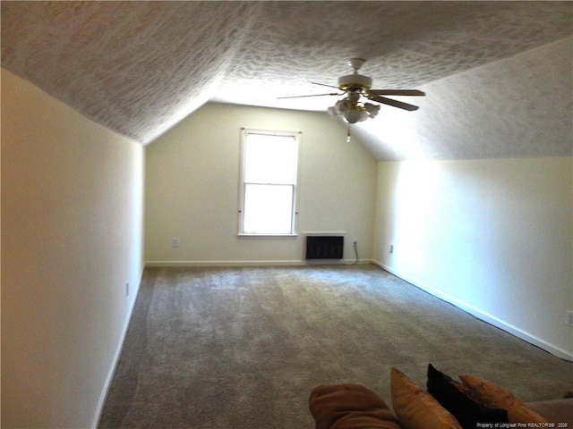 bonus room featuring vaulted ceiling, carpet floors, ceiling fan, and a textured ceiling