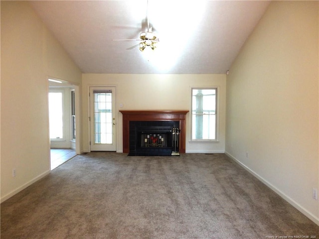 unfurnished living room with carpet floors, vaulted ceiling, and ceiling fan