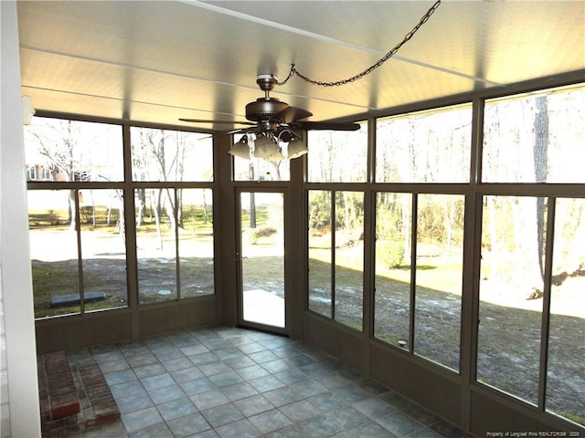 unfurnished sunroom with ceiling fan