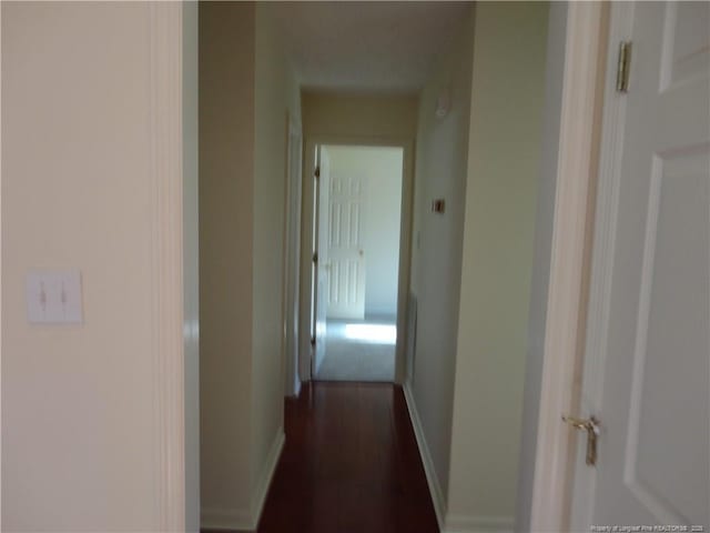 corridor featuring dark hardwood / wood-style flooring