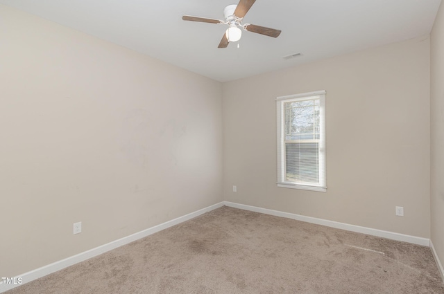 carpeted empty room featuring ceiling fan