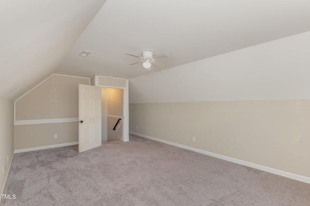 additional living space with lofted ceiling, light colored carpet, and ceiling fan