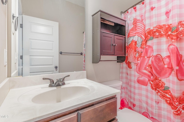 bathroom featuring vanity and toilet