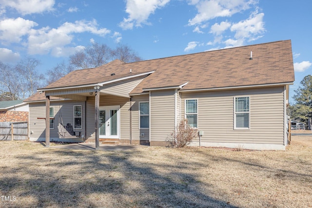 back of property featuring a yard and french doors