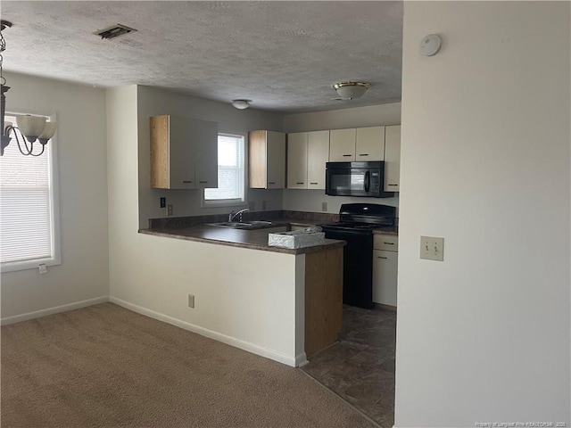 kitchen featuring black appliances, sink, dark colored carpet, kitchen peninsula, and a textured ceiling