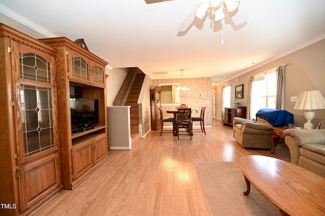 living room featuring crown molding, ceiling fan, and light wood-type flooring